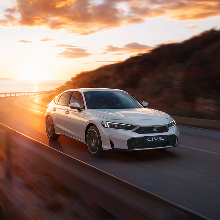 Honda Civic Hybrid driving on a highway.
