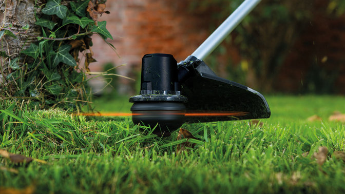 2x honda lawnmower, front three quarters, right facing, garden location.