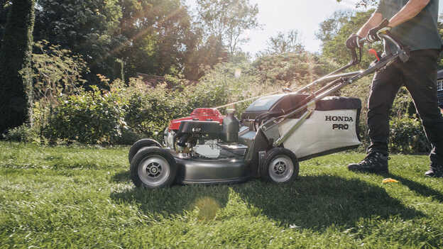 Side facing Honda HRH being used in a garden location. 