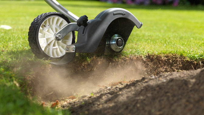 Honda Versatool with edger attachment, in use close up, garden location.