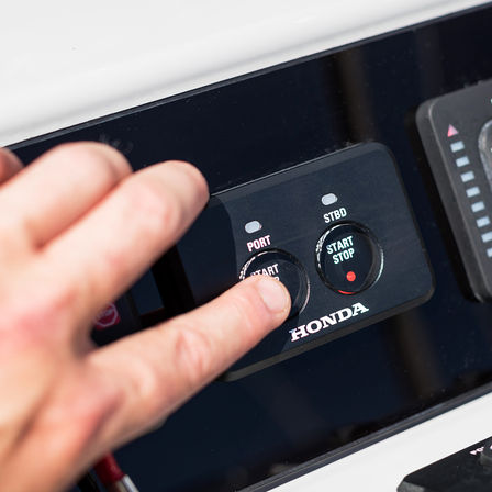 close up of honda outboard engine's start and stop button feature