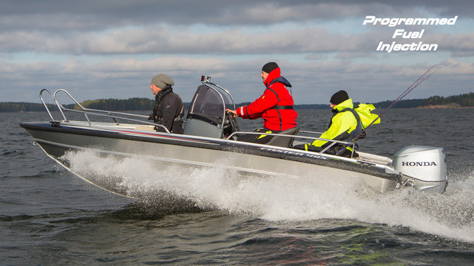 side view of men steering a boat powered by a honda boat engine