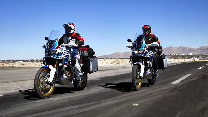 Two riders on Honda Africa Twin Adventure Sports on the road.