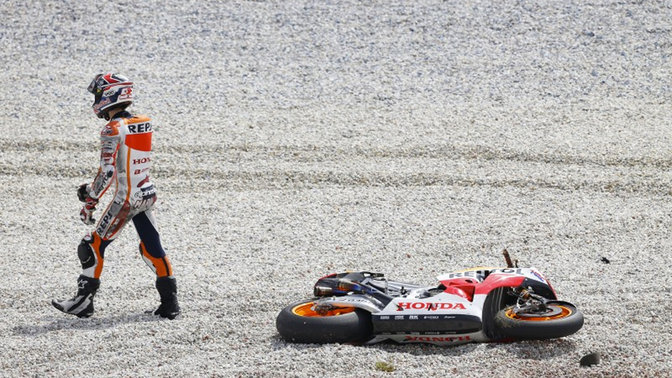 MotoGP racer falling off the motorcycle.