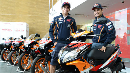 Two MotoGP racers with Honda motorcycles.