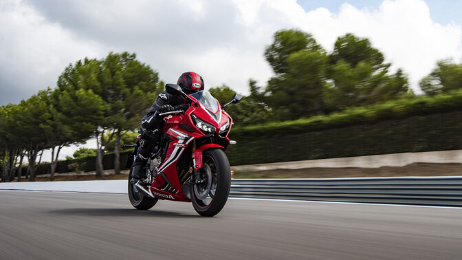 Honda CBR650R ¾ front on racetrack with rider