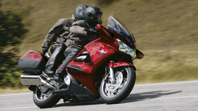 Side, 3-quarter view of Pan-European cornering with rider, road location, right facing.