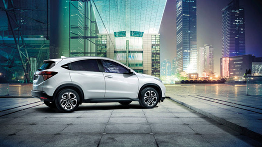 white HR-V on colourful street.