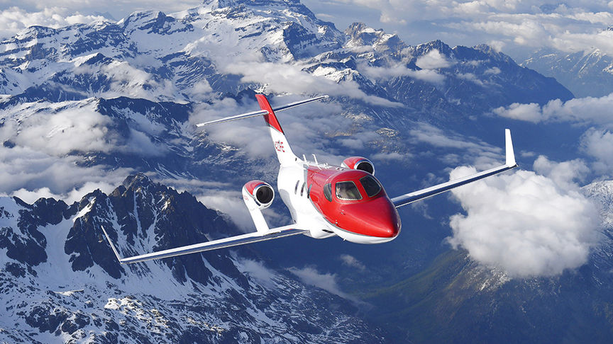 Honda plane flying above mountains