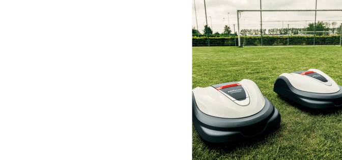 side angled view of honda miimo robot lawnmower mowing a football pitch