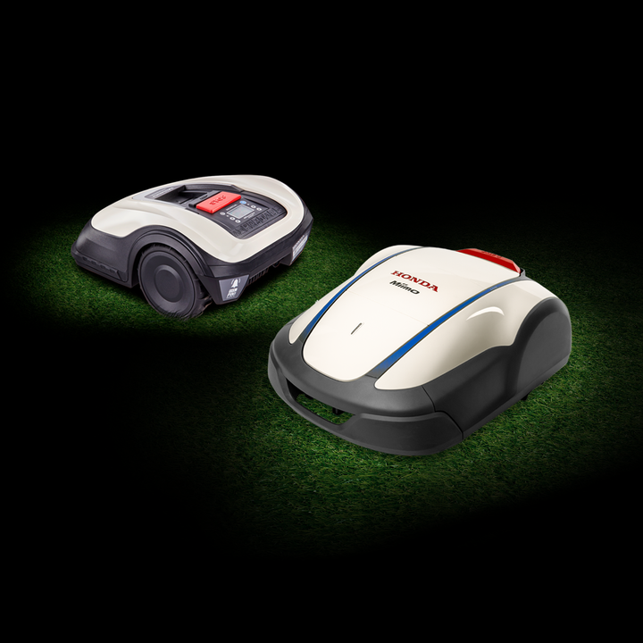 Honda Small Miimo and Honda Miimo on grass in a dark background