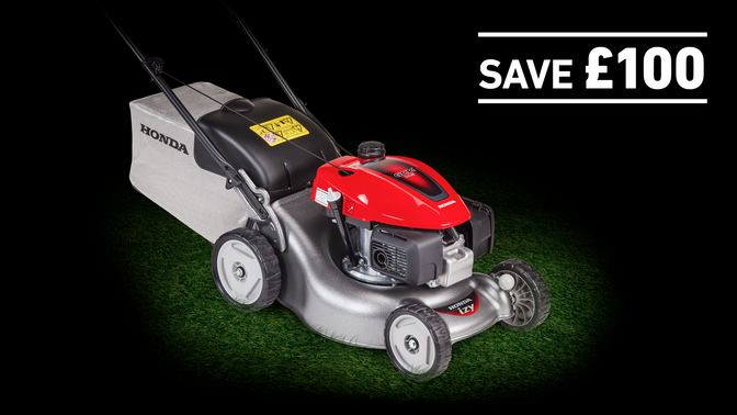 IZY lawnmower on grass in a dark background with save £100