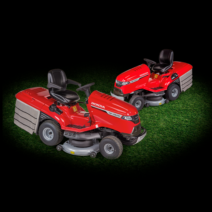 Honda Ride-On mower and Honda Tractor on grass on a dark background