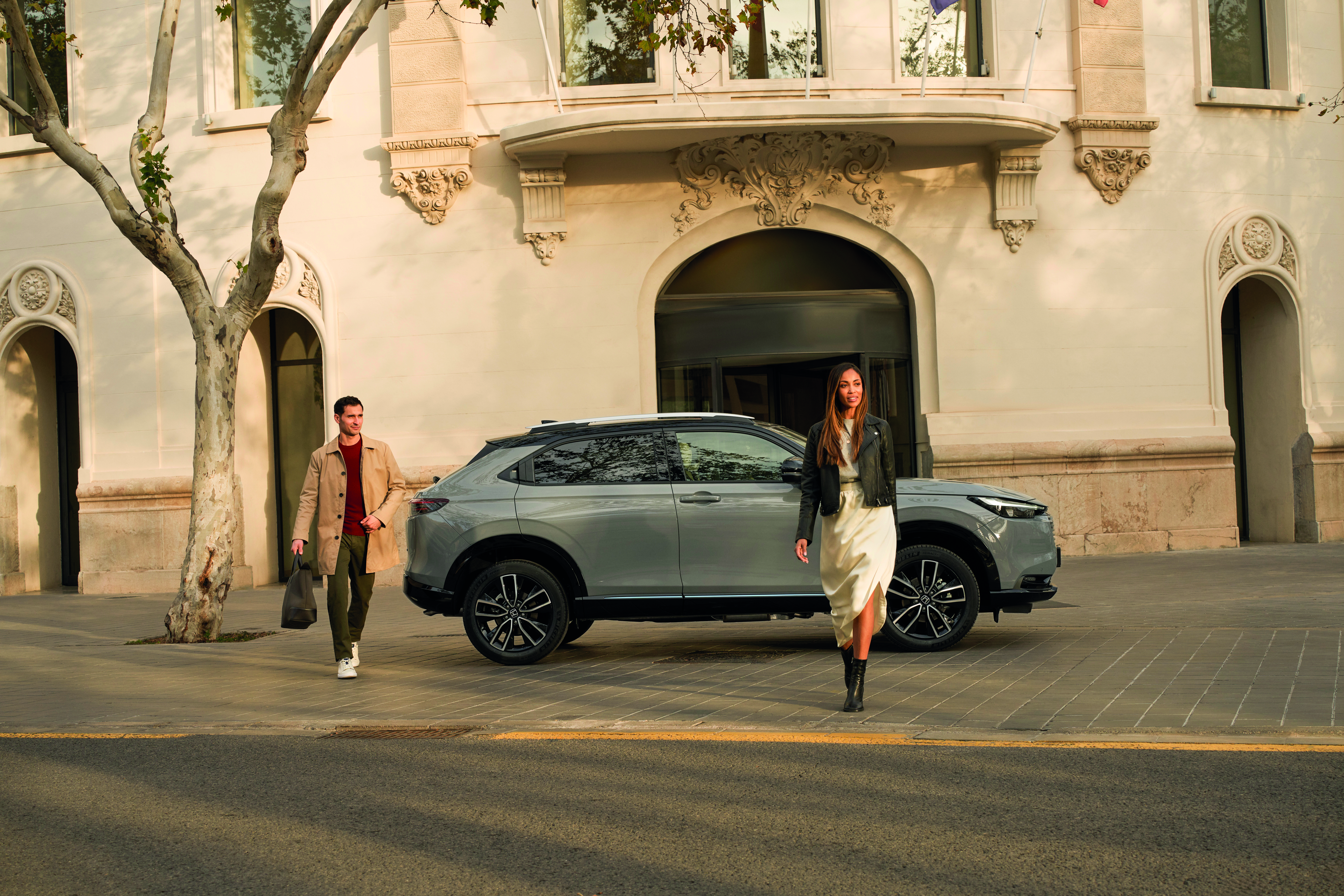 a couple walk away from a Honda car