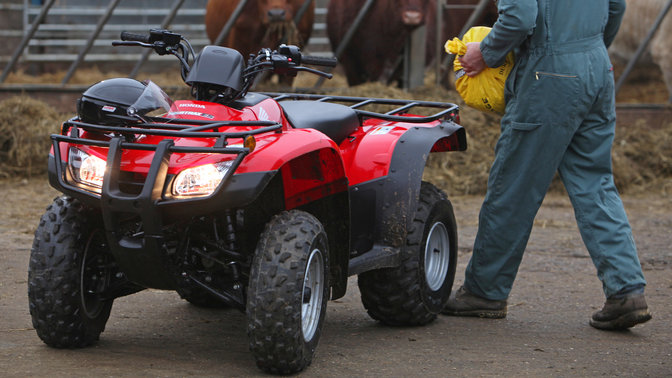 Front three-quarter, left facing Fourtrax 250, farm location.