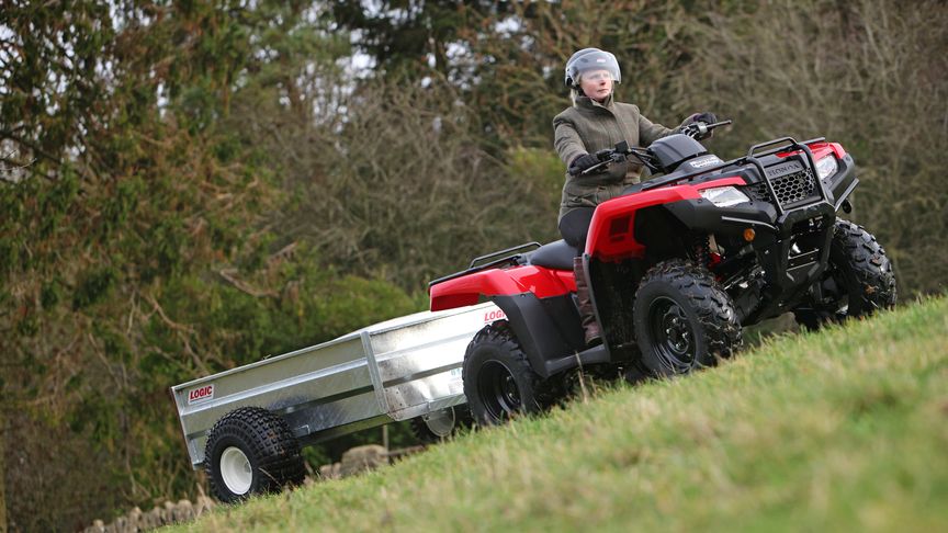 Fourtrax 420 being used by model, steep field location.