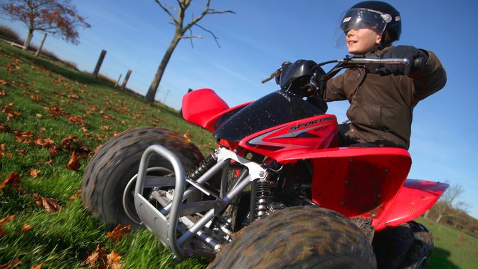 Front three-quarter, left facing Fourtrax 250, farm location.