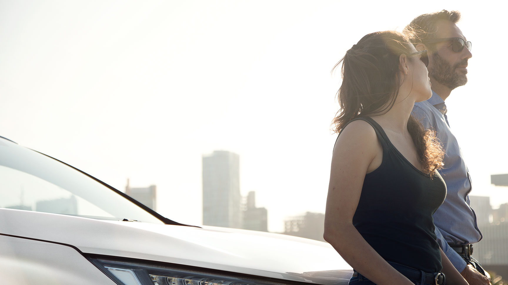 Honda Car passengers leaning on the bonnet