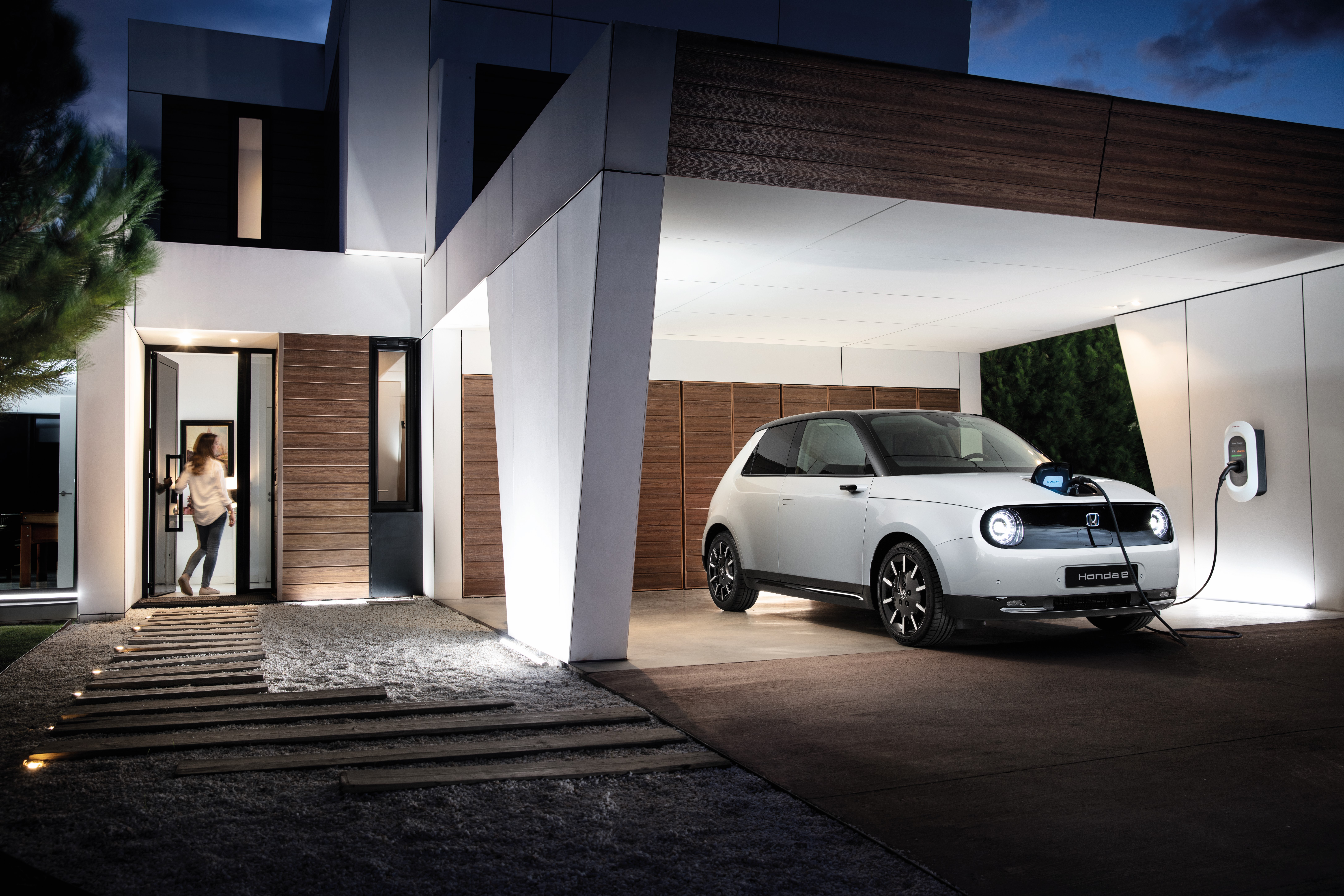 Honda EV car is charging at home at night