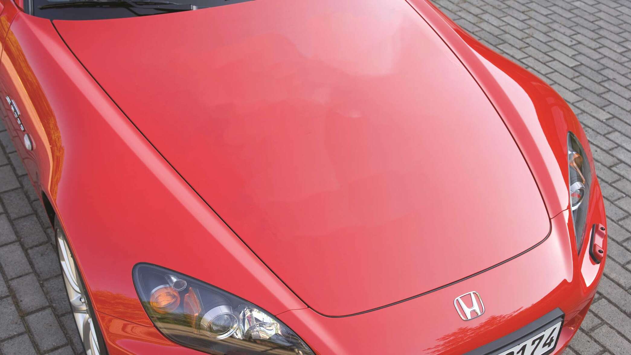 Camera shot of the top of a red Honda S2000.