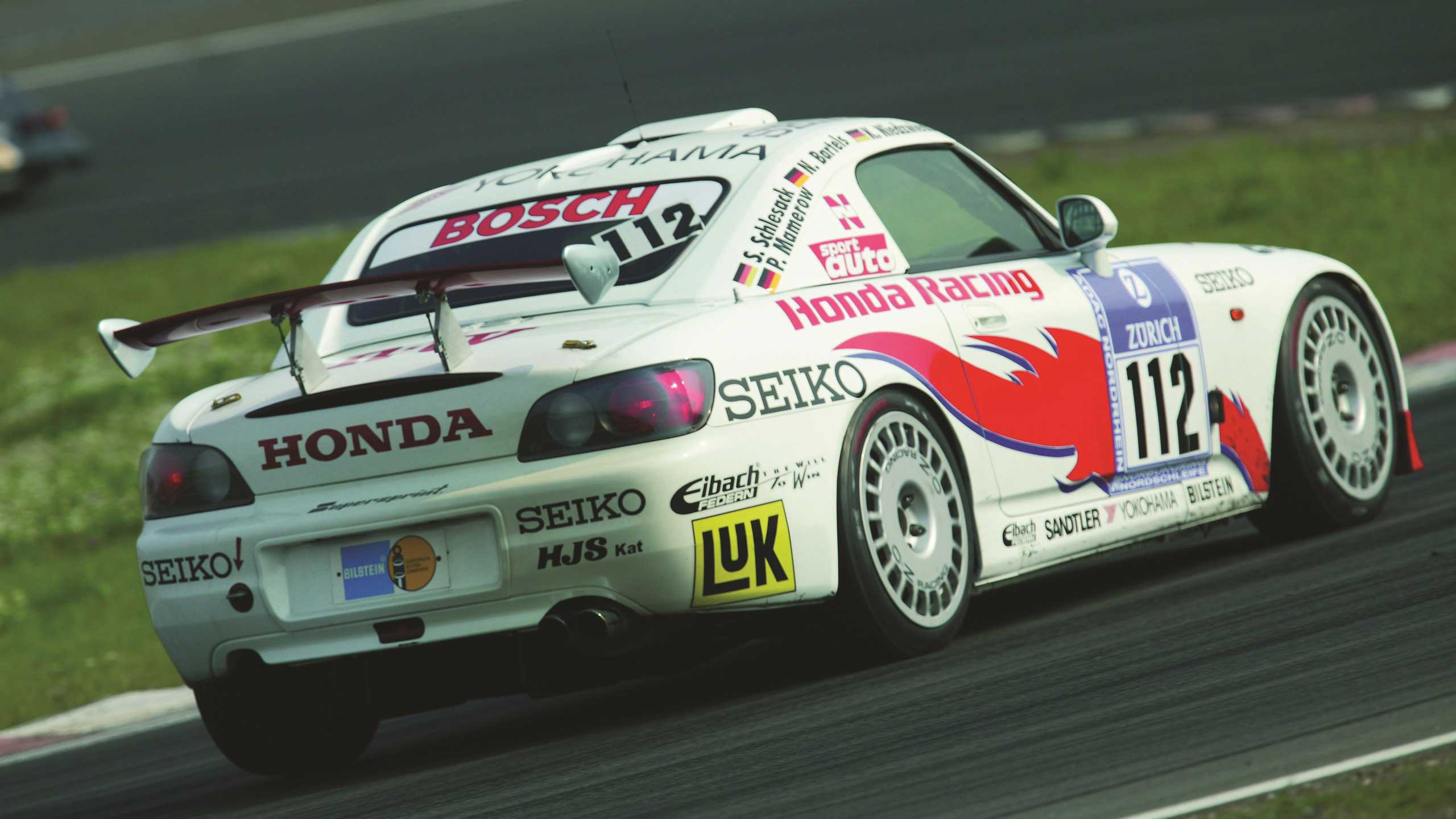 Honda Racing car on racetrack. 