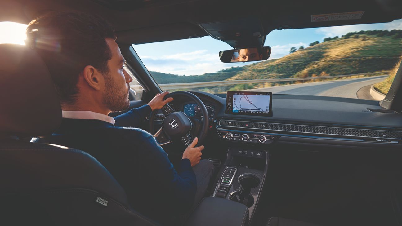 a man driving a Honda Civic
