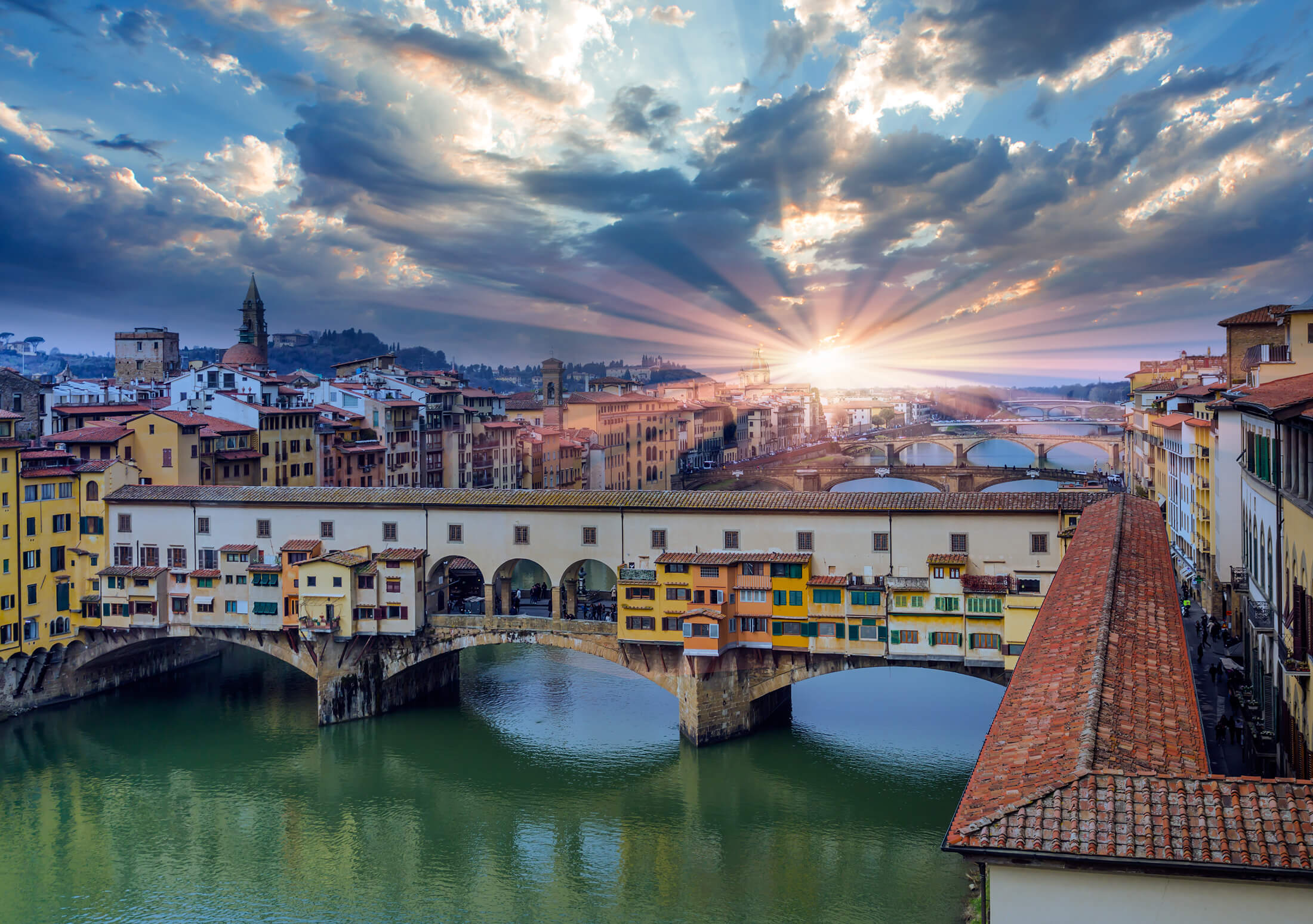 The sun above the Ponte Vecchio in Florence, Italy