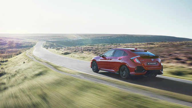 Rear three-quarter facing Honda Civic. Country location.