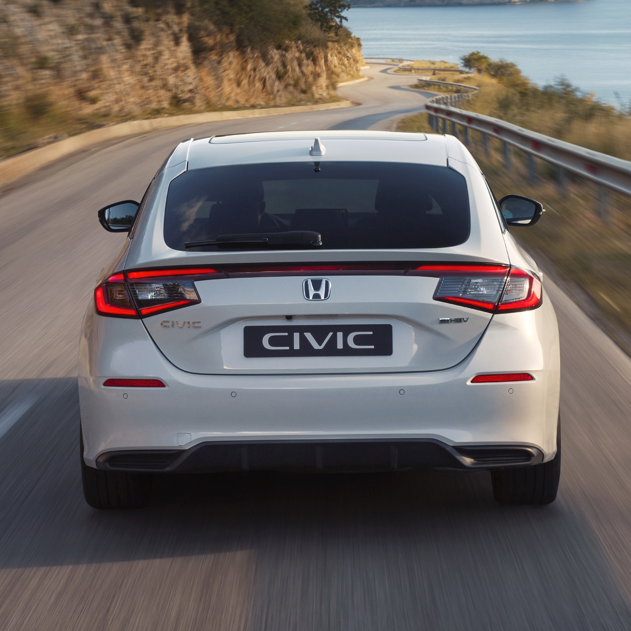 Close up shot of the Honda Civic Hybrid's back, in motion, on a highway.
