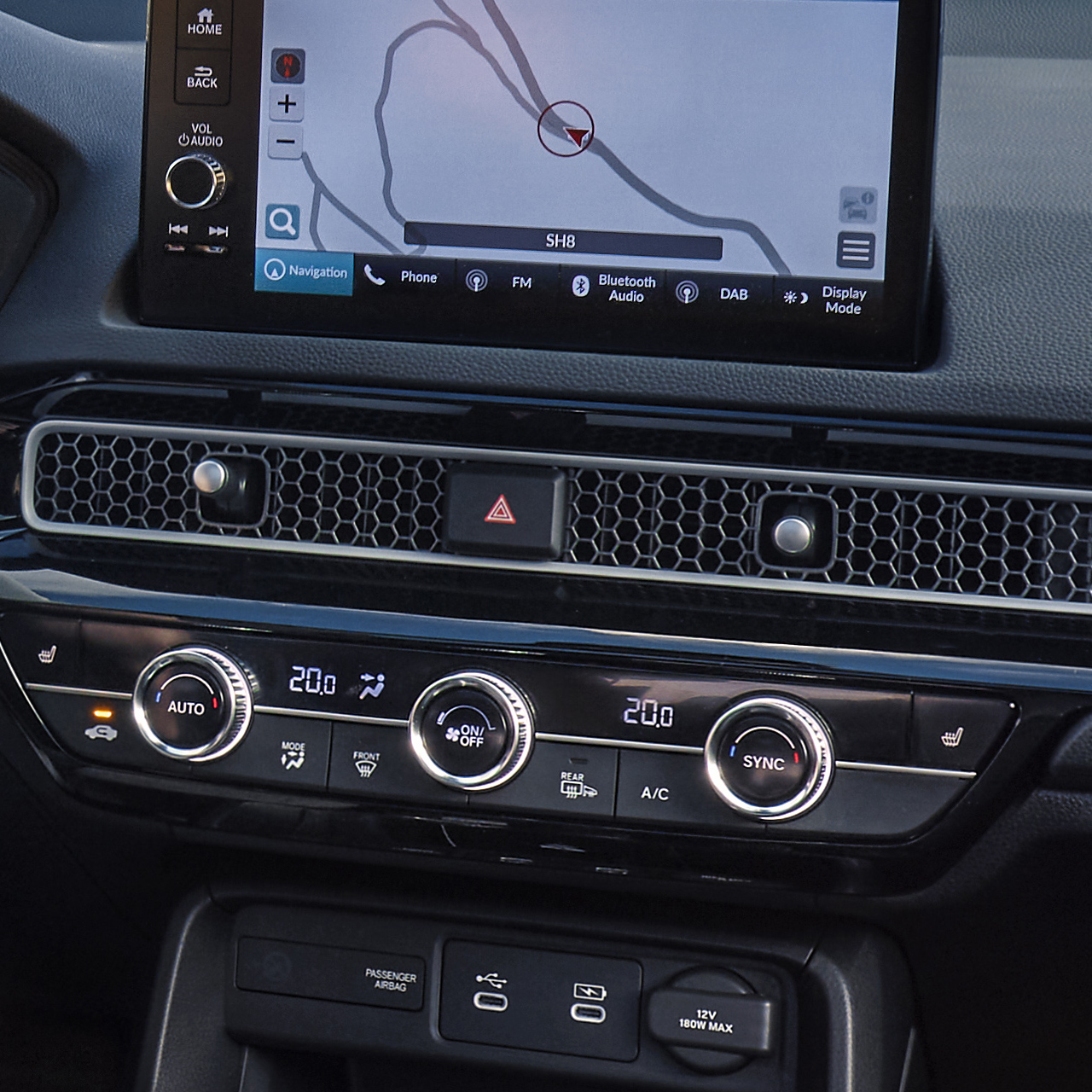 Photo shot from the interior of Civic Hybrid, a man driving on a scenic road.