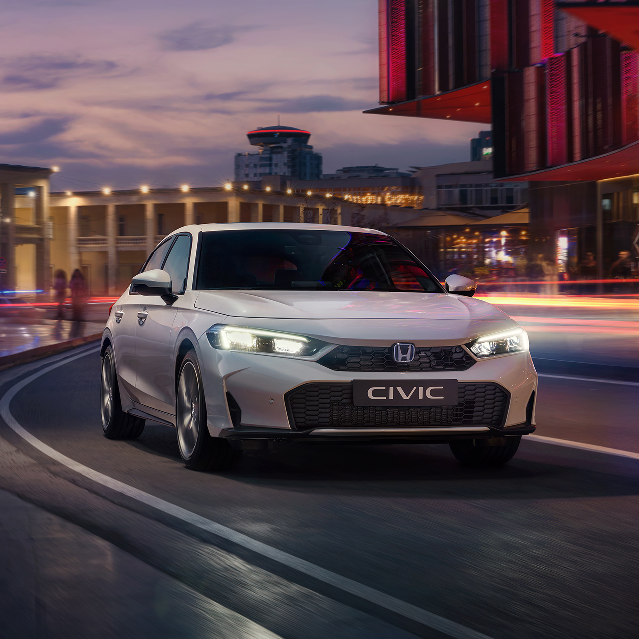Civic Hybrid in a city, on the road, at dawn