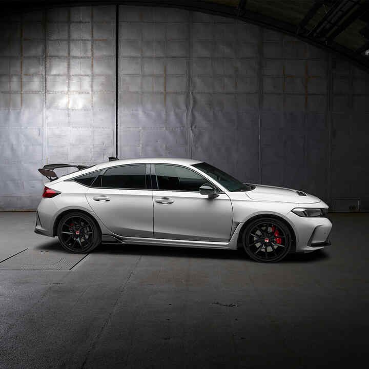 Side facing Honda Type R parked in an garage.