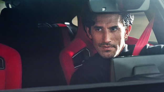 Close up of a driver in the Honda Civic Type r drivers seat.
