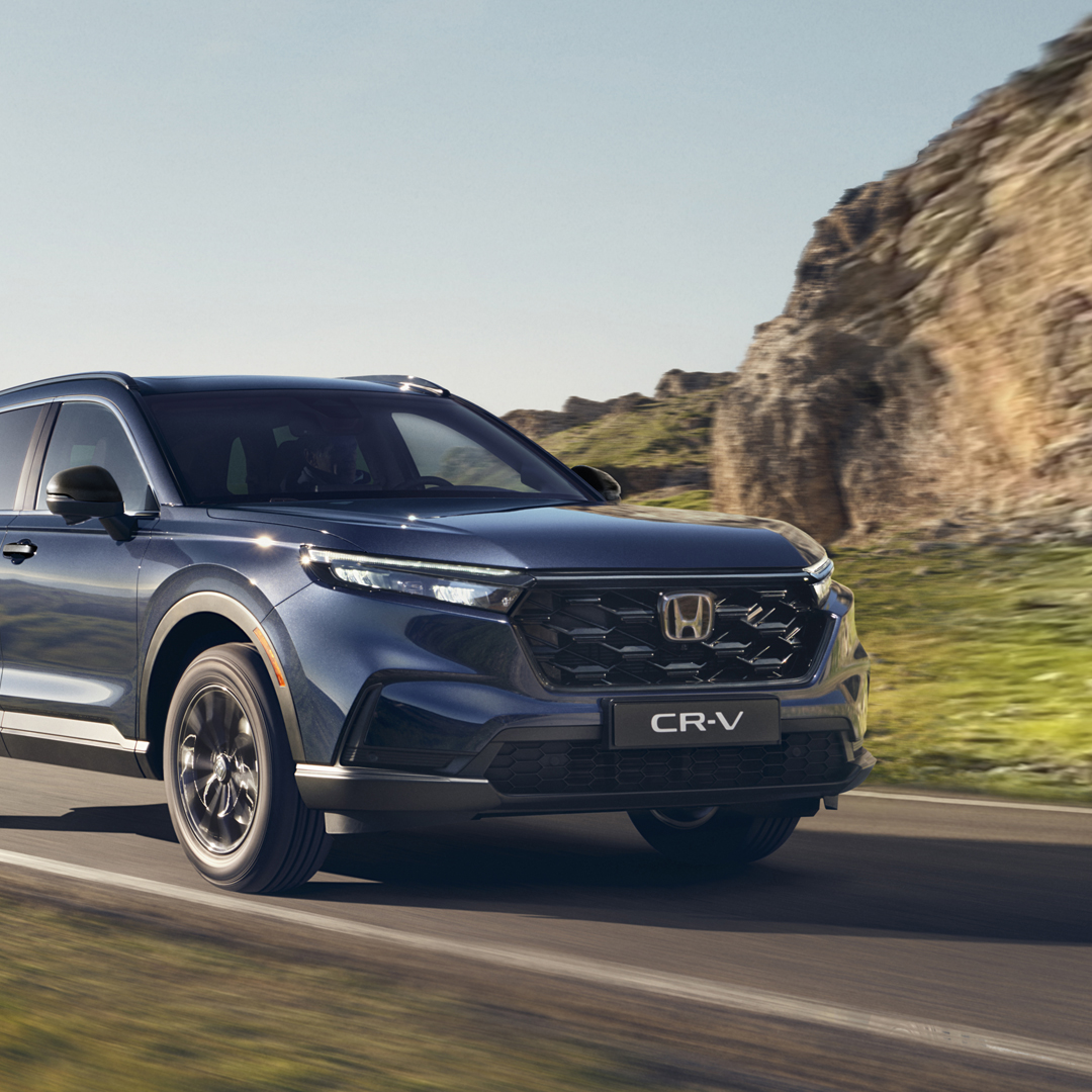 Front three-quarter facing Honda CR-V Hybrid driving in mountain location.