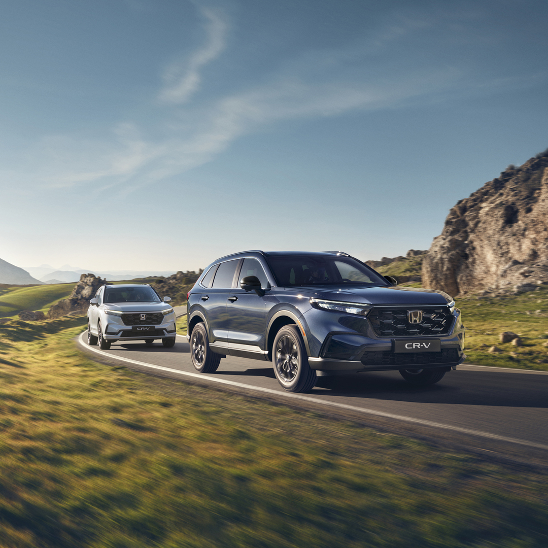 Front three-quarter facing Honda CR-V Hybrid in mountain location.