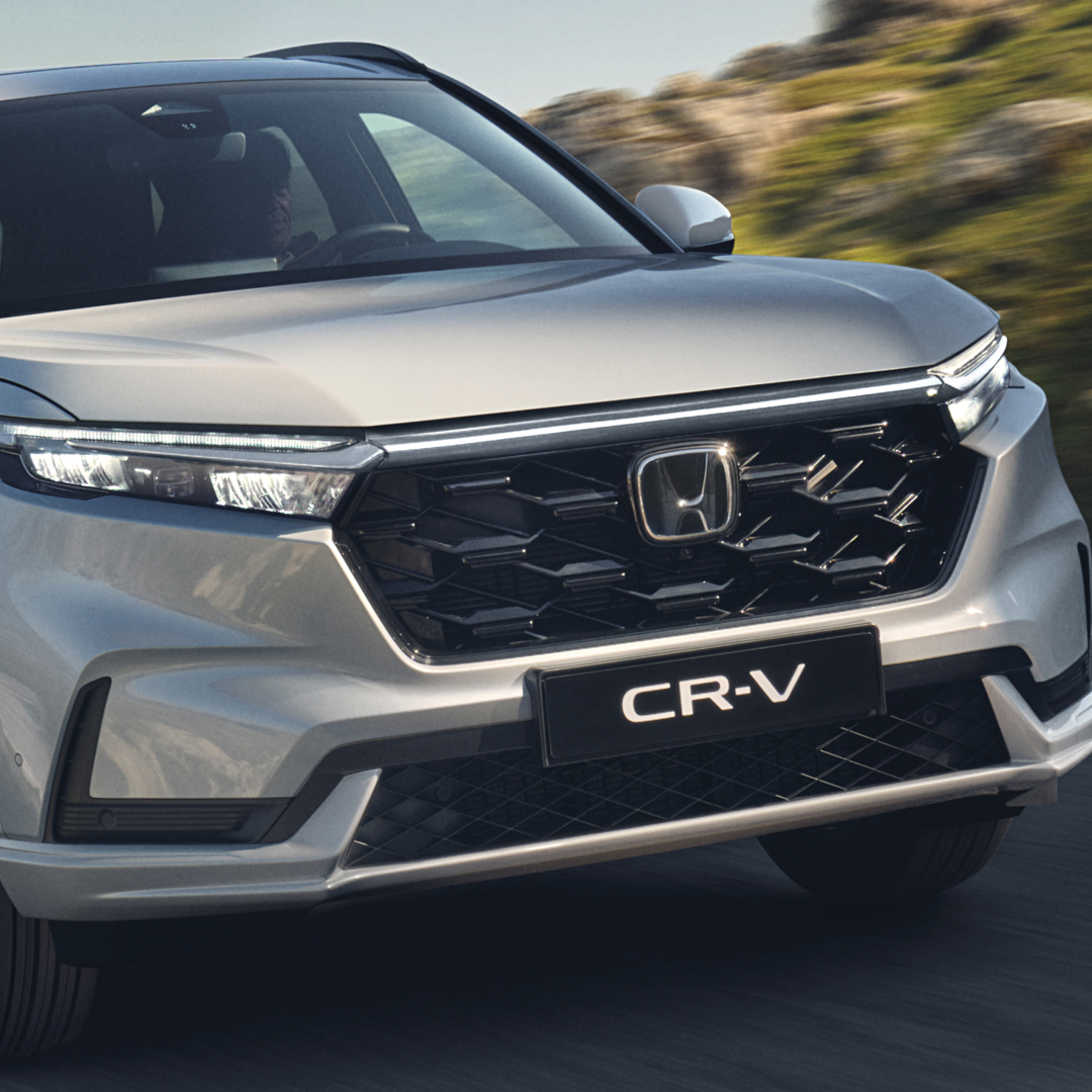 Front three-quarter facing Honda CR-V Hybrid in mountain location.