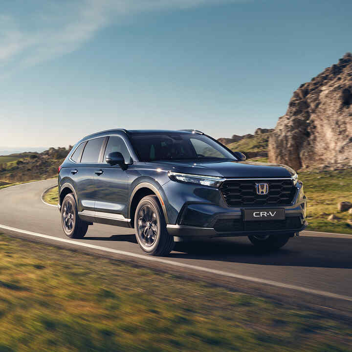 Blue CR-V on a mountain road