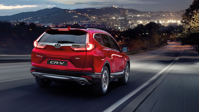 Rear three-quarter facing Honda CR-V, mountain road.