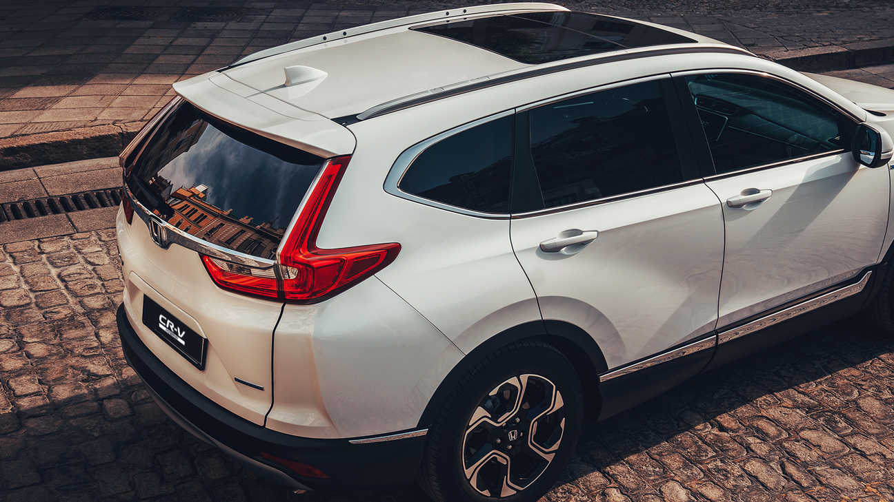 Rear facing view of Honda CR-V Hybrid car in street location.
