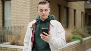 Honda customer looking at a mobile phone.