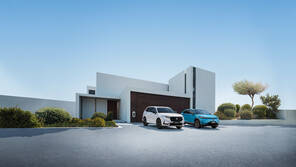 Front three quarter facing Honda vehicles outside house.