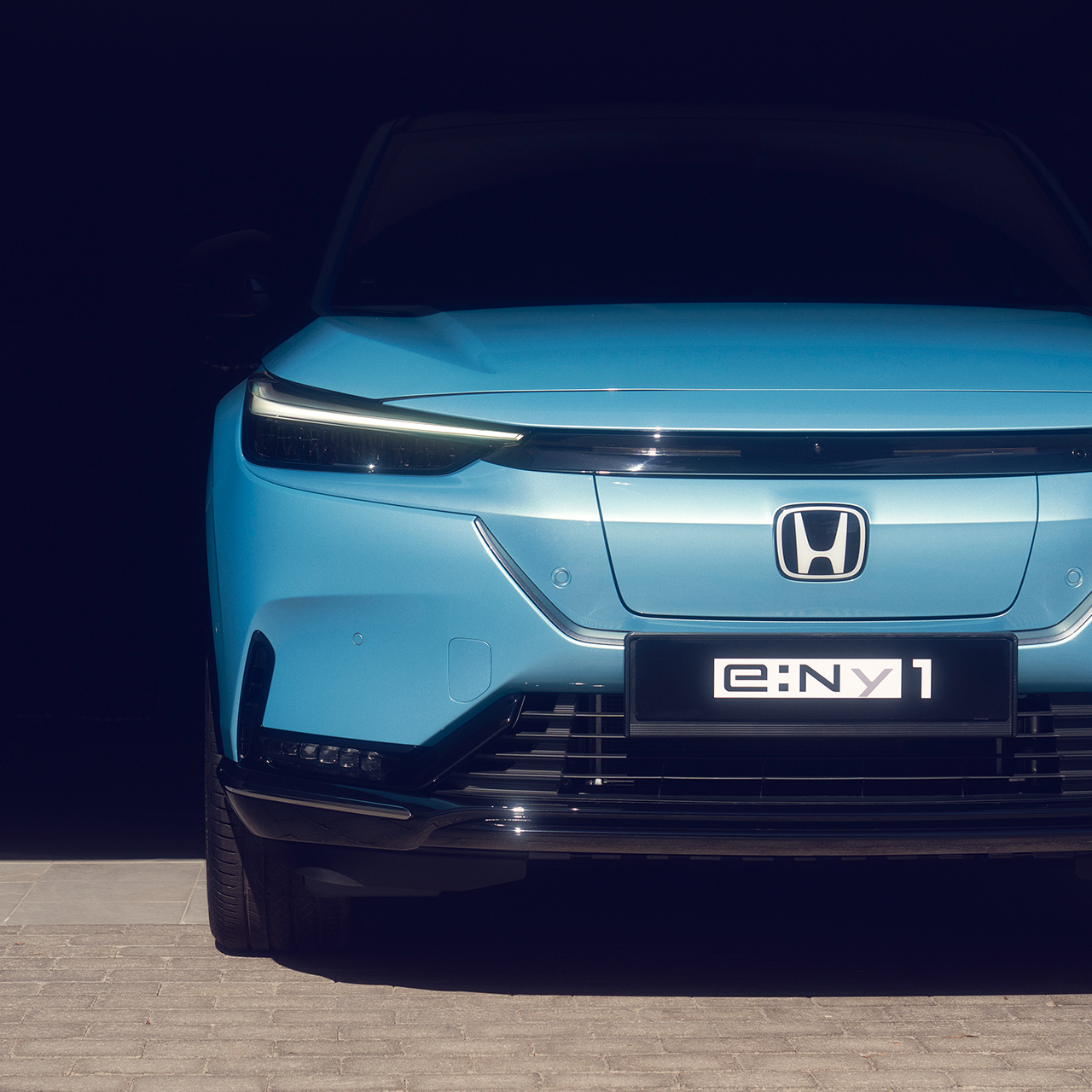 Close up of parked front facing Honda e:Ny1.