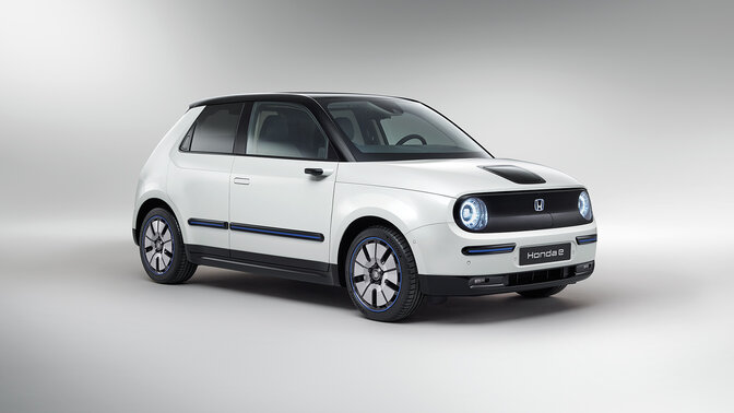 Side facing three quarter Honda e in the studio.
