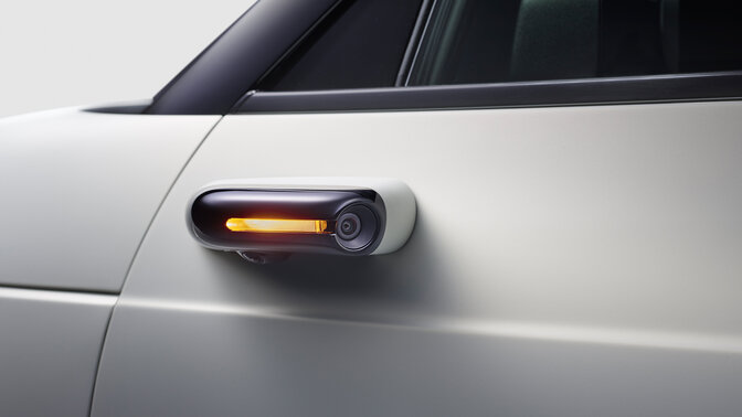 Close up of the side camera mirror system on the Honda e