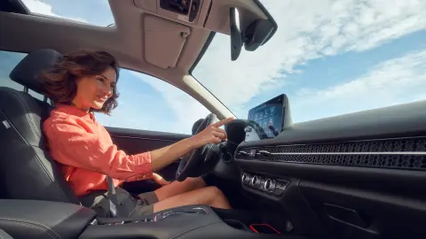 Close up of model sitting inside the ZR-V Hybrid car.