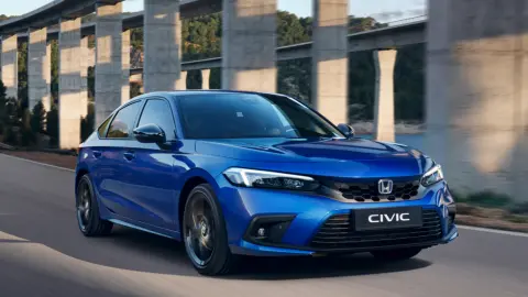 Civic Hybrid blue car driving in a mountain location.