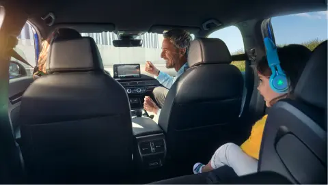 Family sitting inside the Civic Hybrid car.