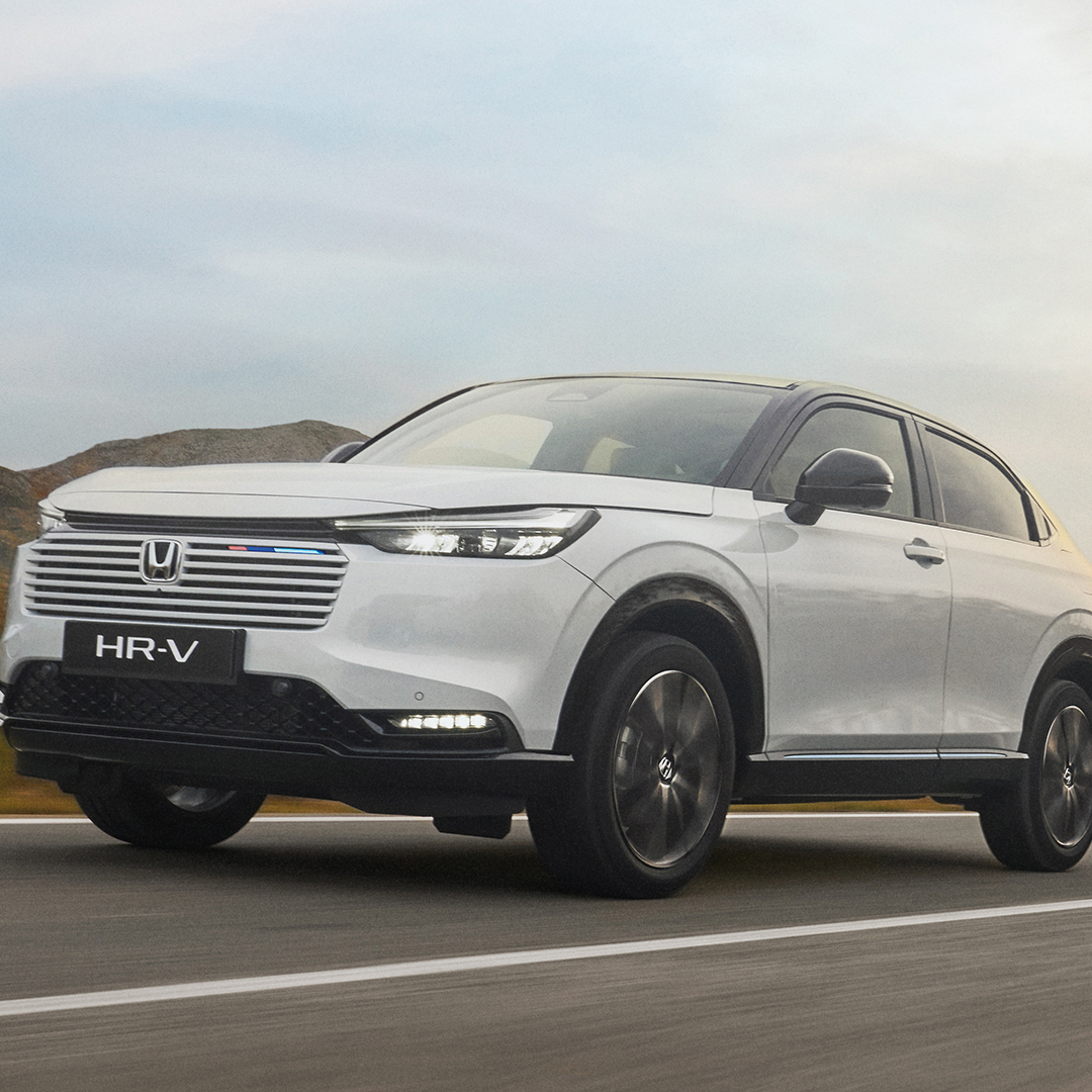 HR-V driving on a clear road. 