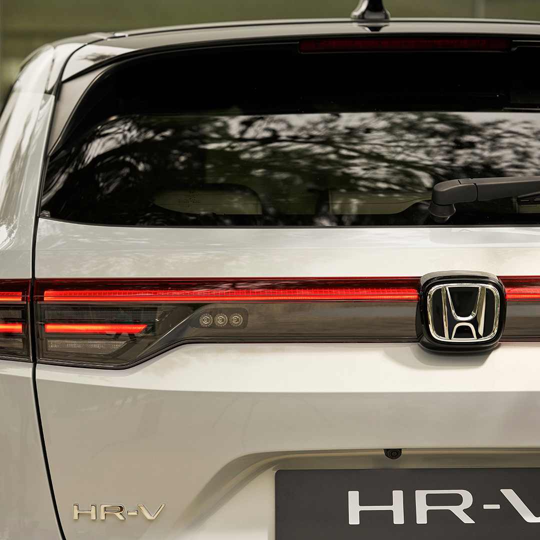 Couple walking next to  HR-V parked outside of building location. 
