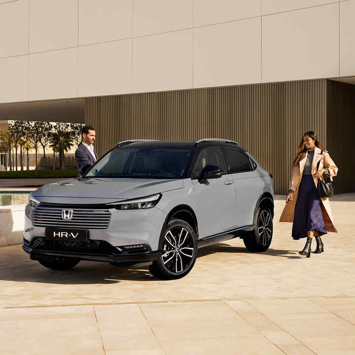 Honda HR-V e:HEV parked up with passengers approaching to get in the car.